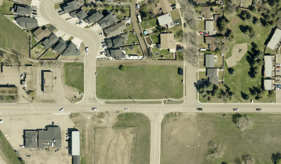 Satellite view of 1064 1 Street SW in City of Medicine Hat, with the parcel boundary outlined