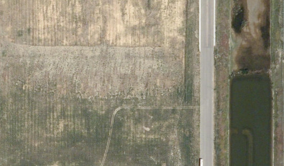 Satellite view of 3990-32 St N in City of Lethbridge, with the parcel boundary outlined