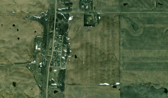 Satellite view of NW-26-33-26-W4 in Kneehill County, with the whole shared parcel, not this unit outlined